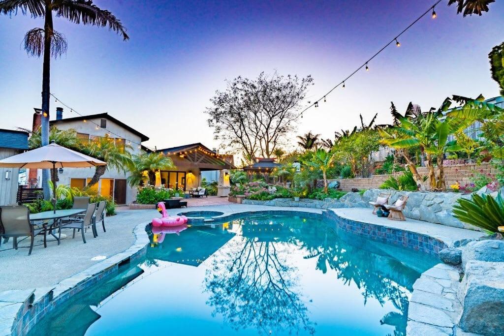 a swimming pool with a pink duck in the middle at Resort style back yard heated pool and spa in Encinitas