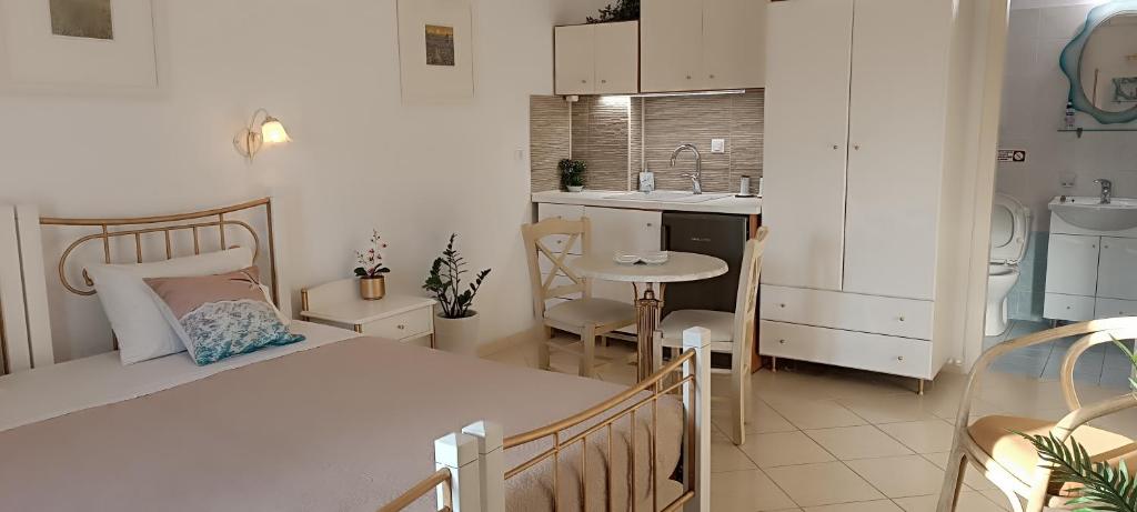 a small kitchen with a bed and a table in a room at Actis studios 1 in Stelida