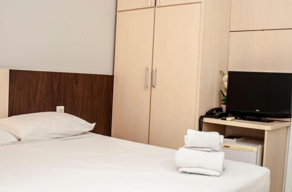 Postel nebo postele na pokoji v ubytování SMART IGUASSU HOTEL