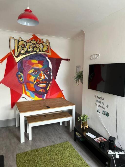 a living room with a large painting on the wall at 2-Bedroom Flat w/ En-Suites, Perfect for Groups in Liverpool