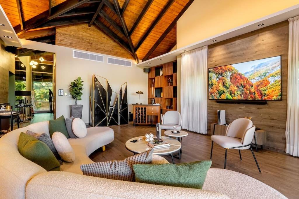 a living room with a large painting on the wall at Modern village between mountains Villa la Justina in Constanza