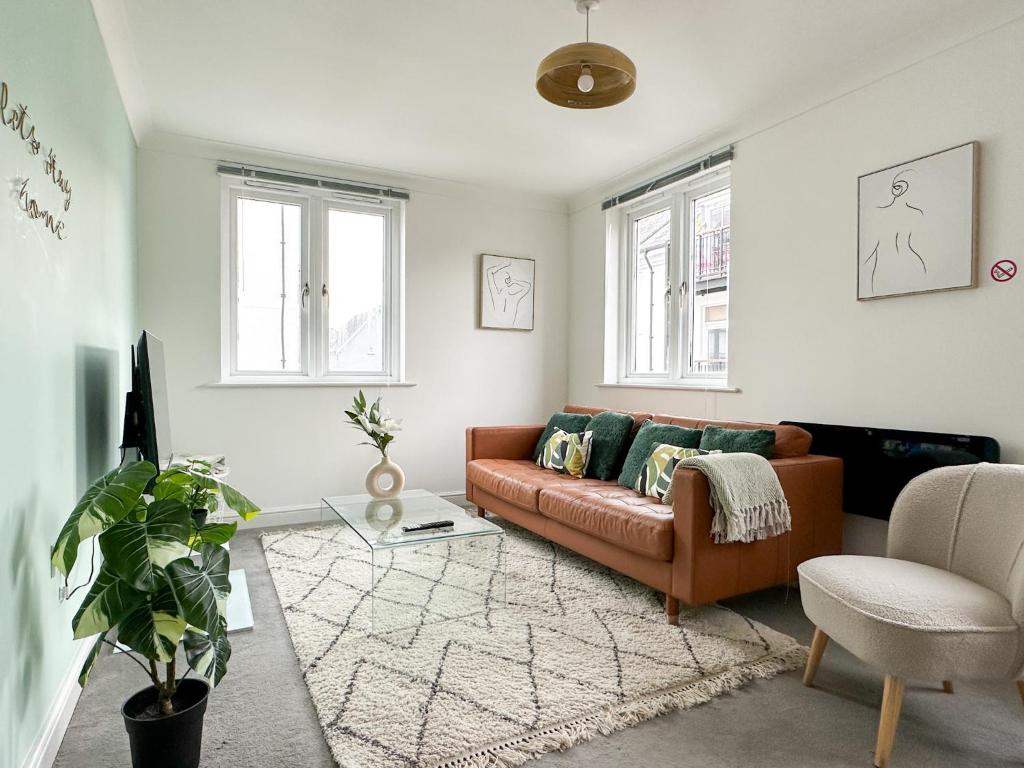 a living room with a couch and a chair at Luxury 2 Bedroom City Centre Apartment - Secure Parking - Amazing location! in Canterbury