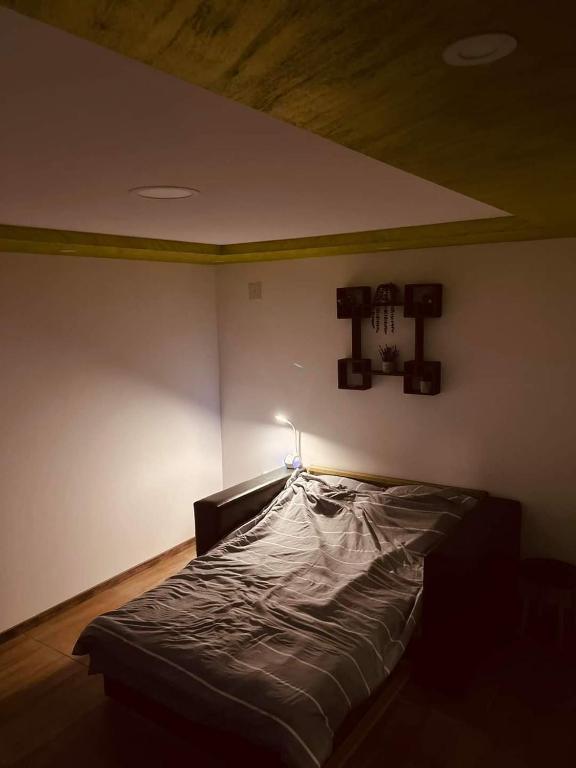 a large bed in a room with a ceiling at NP Apartman Banja Jokin Grab -Bogatić 