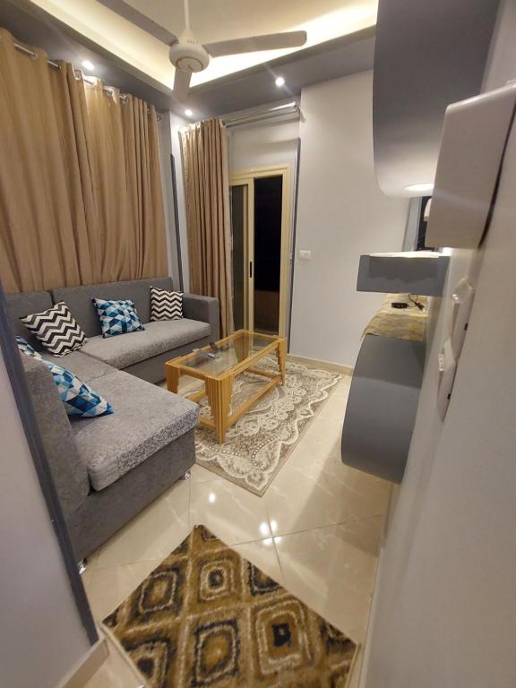 a living room with a couch and a table at Luxor apartment in Luxor