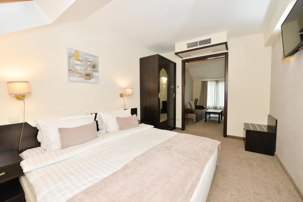 a bedroom with a large white bed in a room at Art Plaza Hotel in Sofia