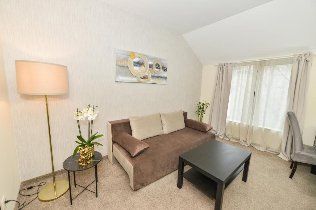a living room with a couch and a table at Art Plaza Hotel in Sofia