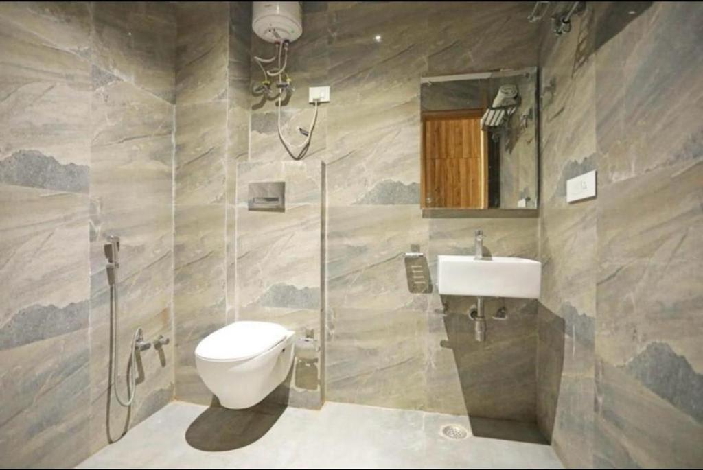 a bathroom with a toilet and a sink at Hotel Airport inn plaza near delhi airport Aerocity in New Delhi