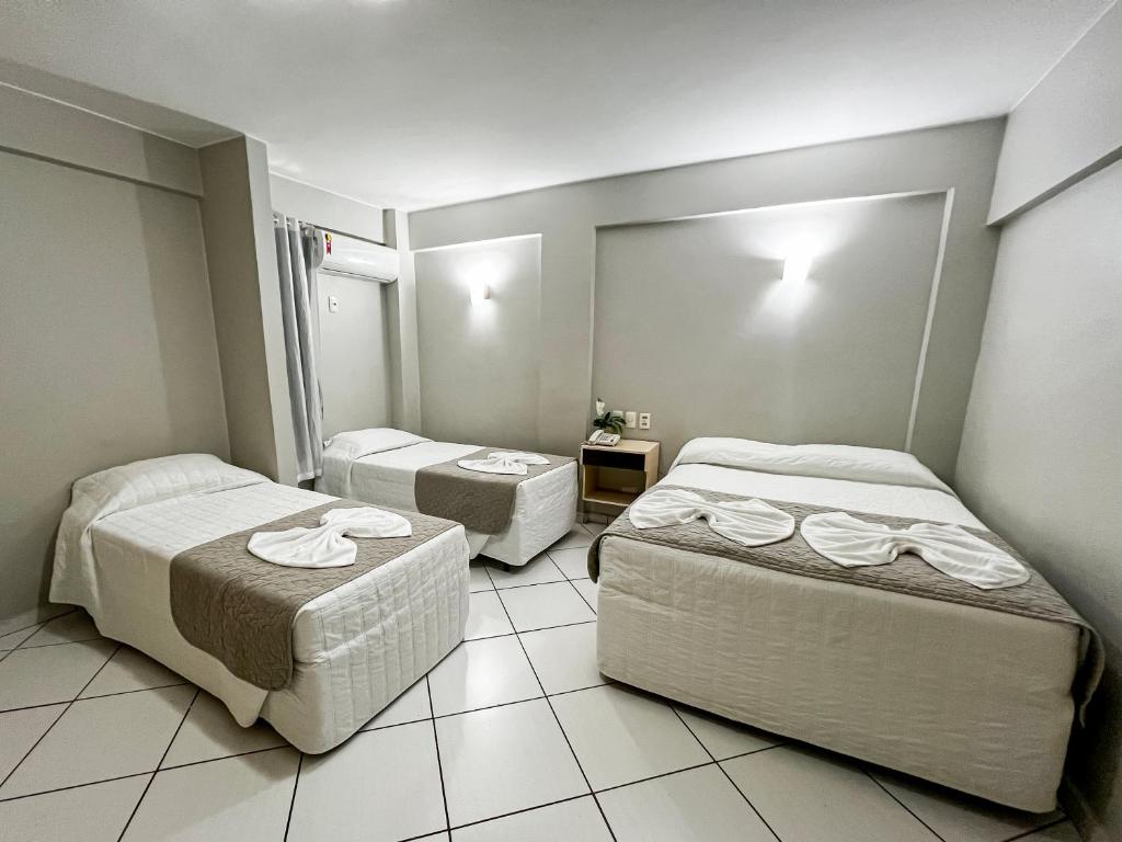 Postel nebo postele na pokoji v ubytování SMART IGUASSU HOTEL