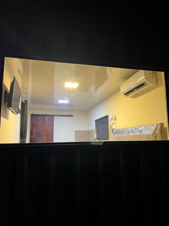 a view of a room through a glass window at Container Home Py in Puerto Presidente Franco