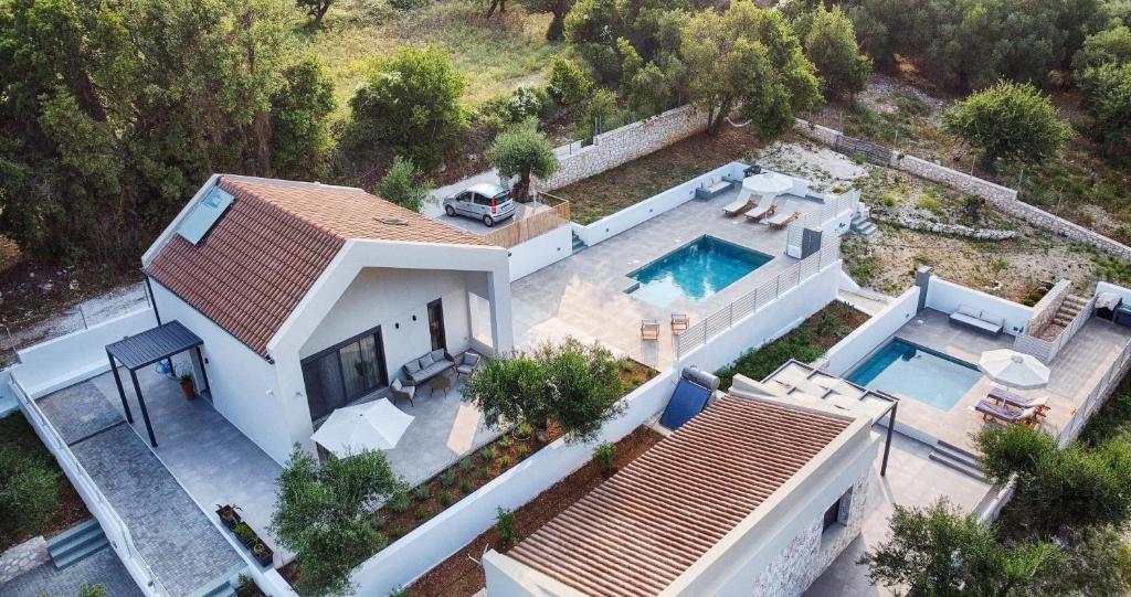 an aerial view of a house with a swimming pool at Myrtia Villas I in Anomeriá