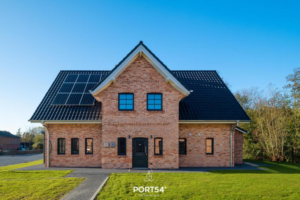 a house with solar panels on the roof at Lake House in Osterhever