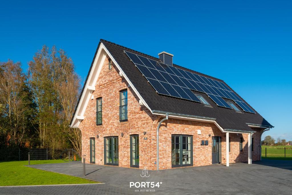 a house with solar panels on the roof at Flamingo Bay in Osterhever