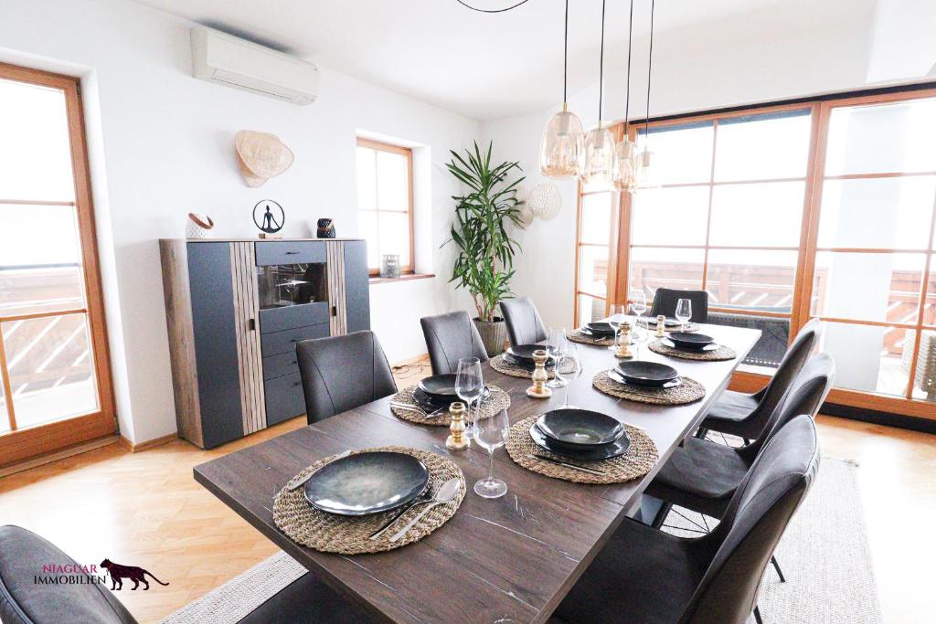 a dining room with a wooden table and chairs at Naturtalente Berghaus - Apartment 4 in Innerschwand am Mondsee