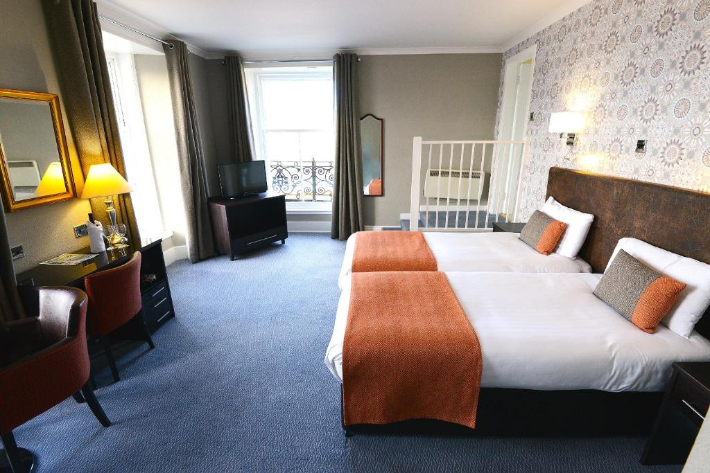 Postel nebo postele na pokoji v ubytování Columba Hotel