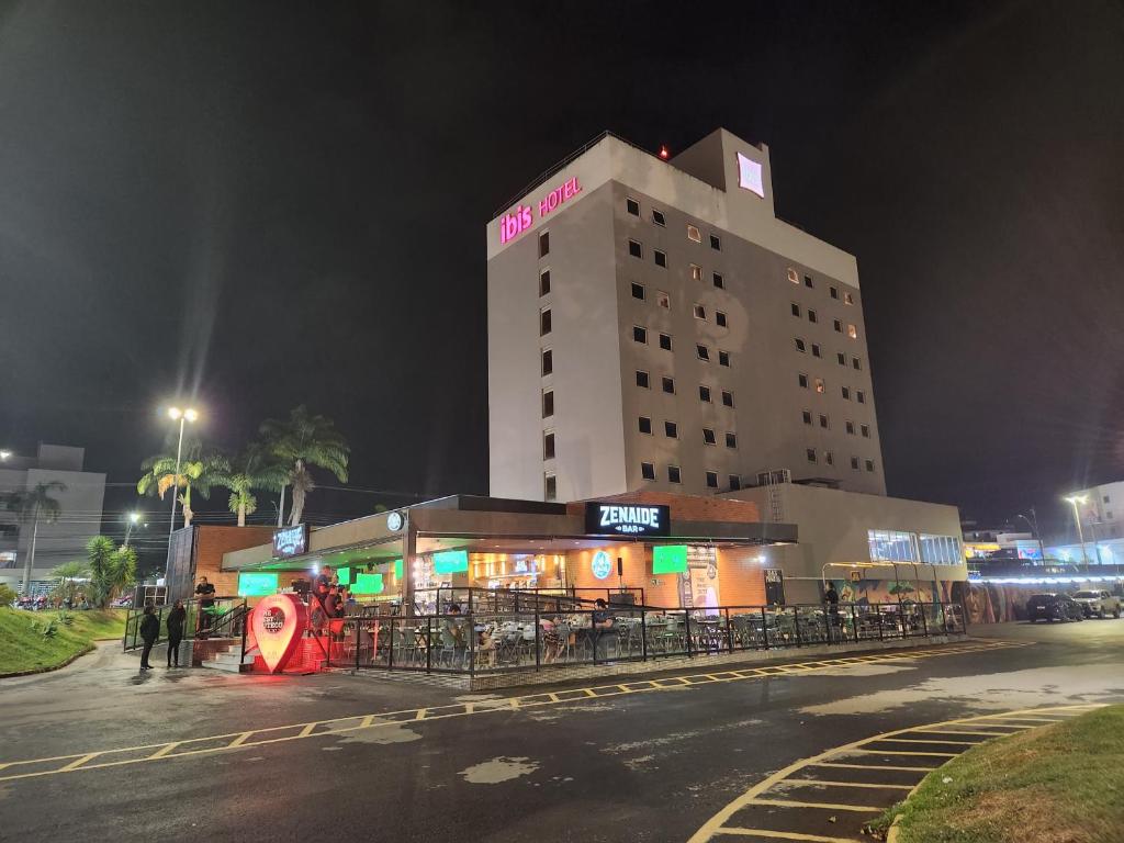 a building with a sign on it at night at ibis Montes Claros Shopping in Montes Claros