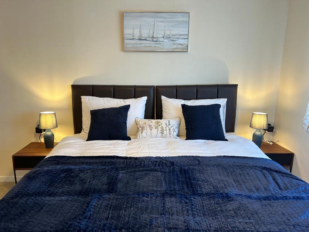 a bedroom with a large bed with blue sheets and pillows at Home in Oxford in Oxford