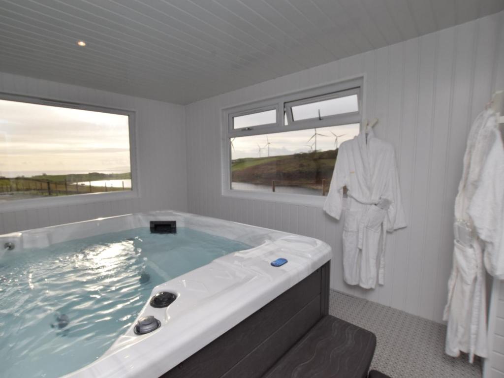 a bathroom with a large bath tub with a window at 2 bed in Seamill 78991 in Ardrossan