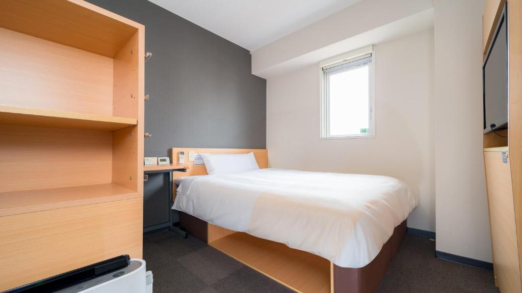 Postel nebo postele na pokoji v ubytování Super Hotel Yonago Ekimae