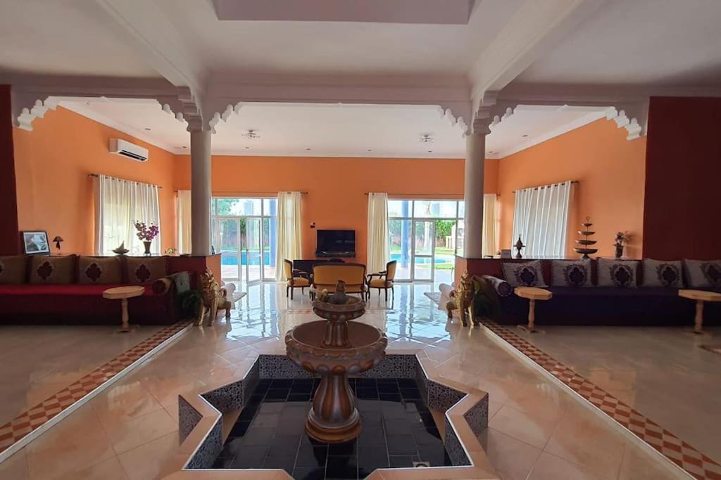 ein großes Wohnzimmer mit Sofas und einem Tisch in der Unterkunft Marrakech Luxury Villa Farm in Marrakesch