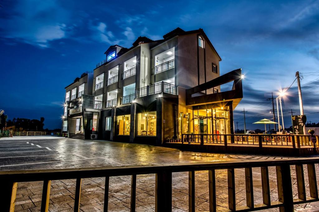 a building on a pier at night at Narsha Resort in Seogwipo