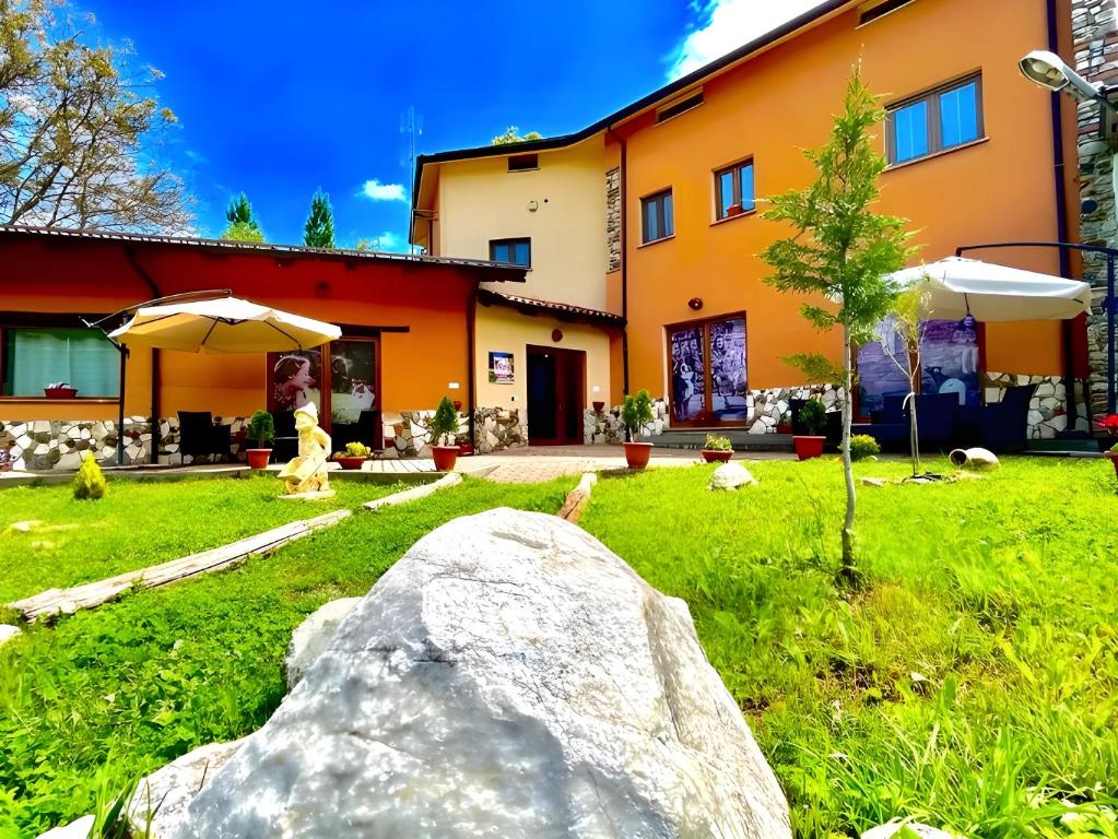 a large rock in the yard of a house at Agriturismo Tre Elle in Acri