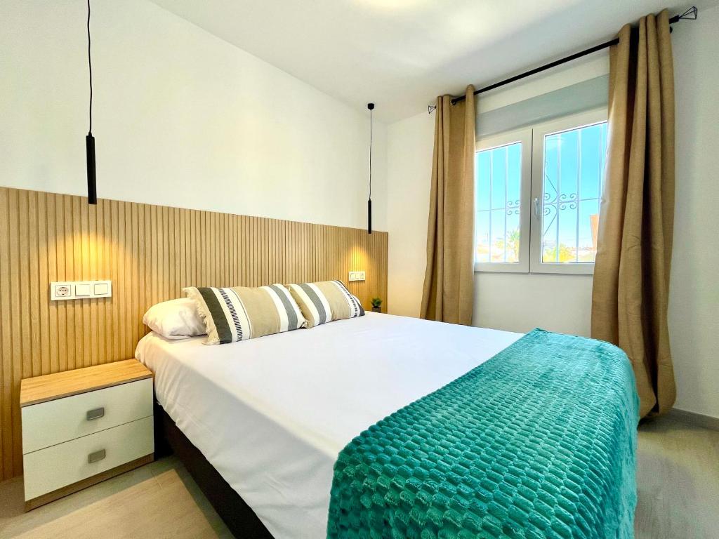 a bedroom with a large bed and a window at Perseo by Albir Proper Properties in Albir