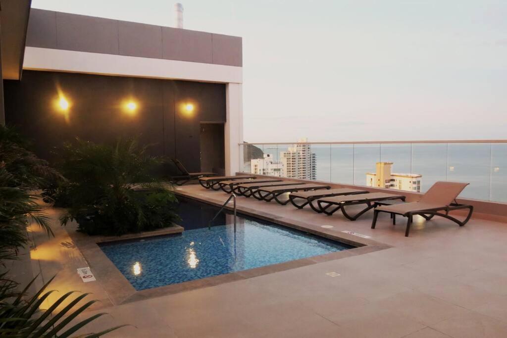 a balcony with a swimming pool on a building at Rodadero- Ámbar Deluxe in Santa Marta