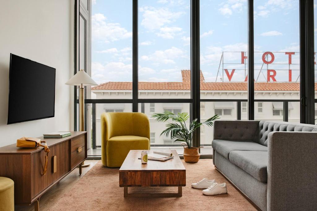 a living room with a couch and a tv at Sonder 17WEST in Miami Beach