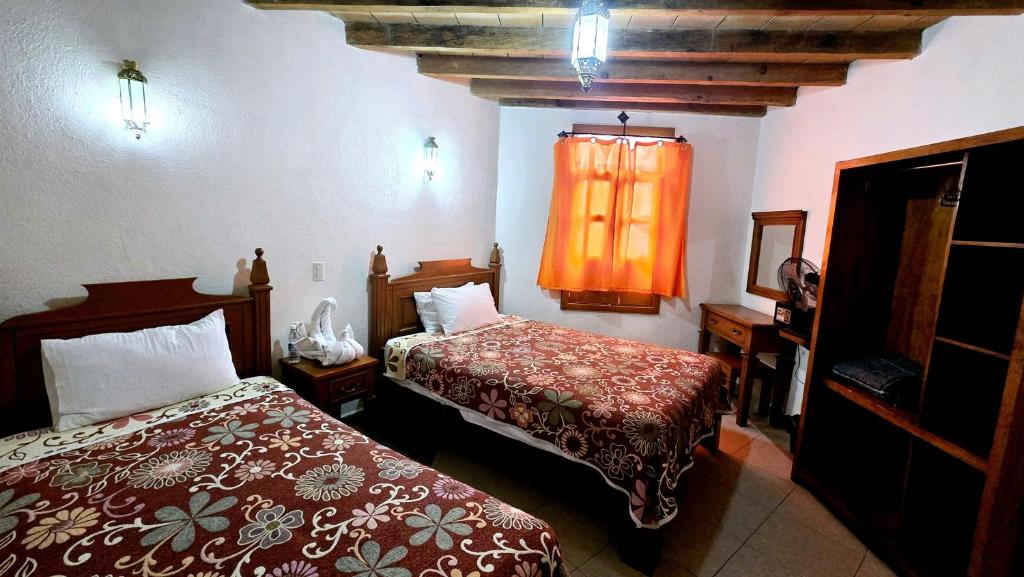 Postel nebo postele na pokoji v ubytování Hotel Plaza Baratillo
