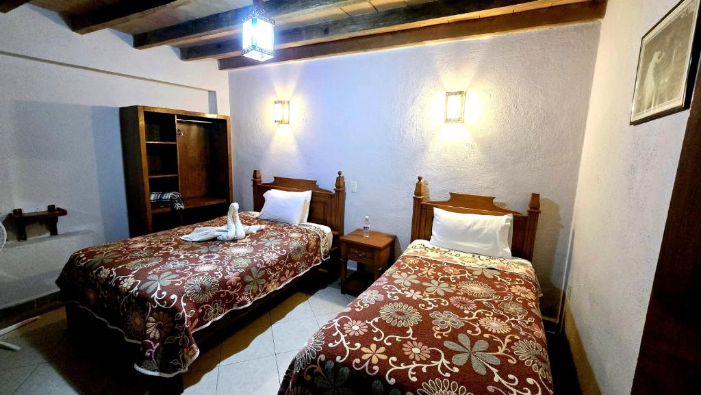 Postel nebo postele na pokoji v ubytování Hotel Plaza Baratillo