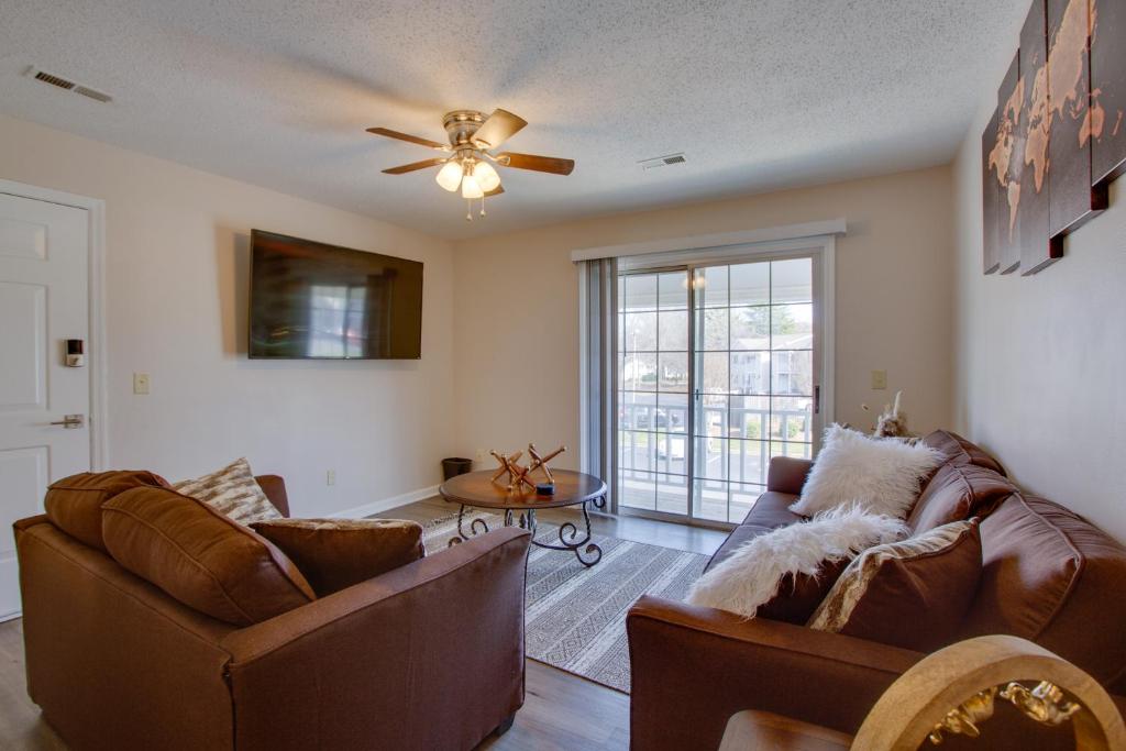 a living room with two couches and a ceiling fan at Greensboro Vacation Rental Condo Near Downtown in Greensboro