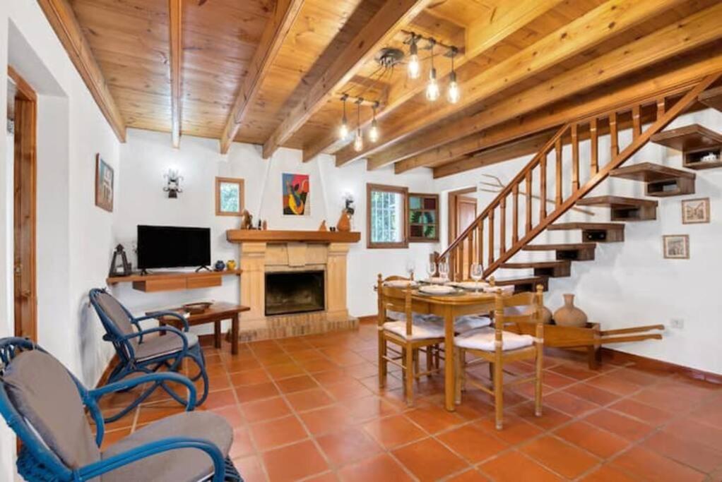 a living room with a staircase and a table and chairs at Villa Anna in Jávea