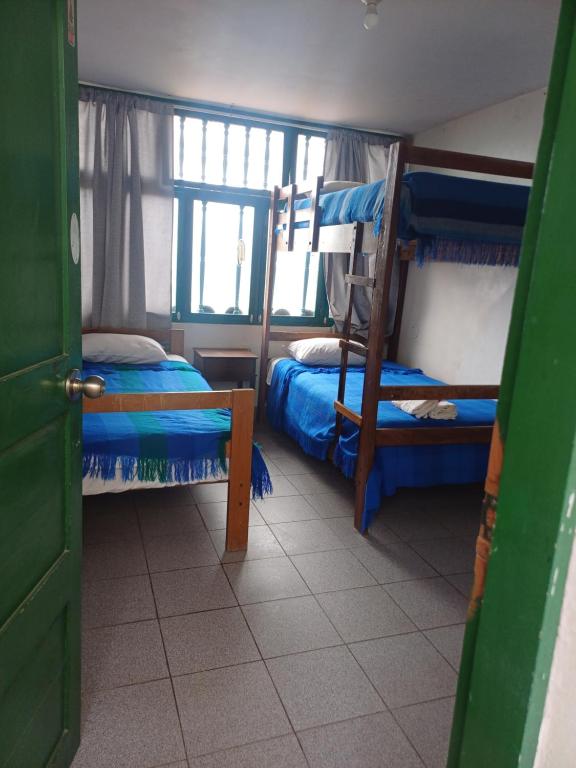 a bedroom with two bunk beds and a window at JULIA'S HOUSE in Huanchaco