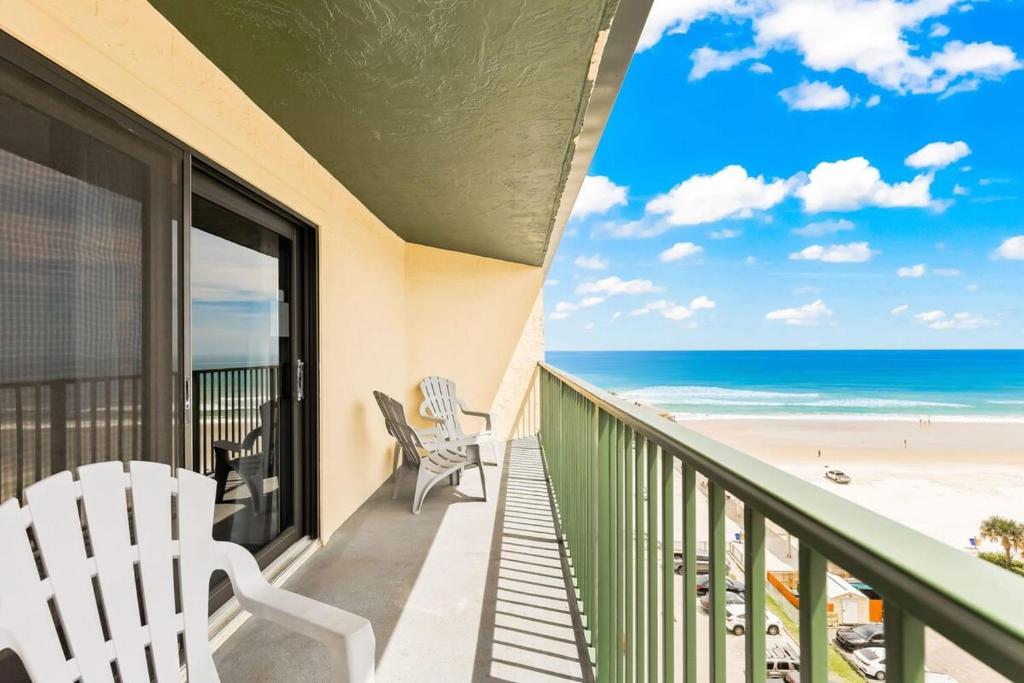 a balcony with chairs and a view of the beach at Ocean Views from Your Private Balcony! Sunglow Resort 907 by Brightwild in Daytona Beach Shores