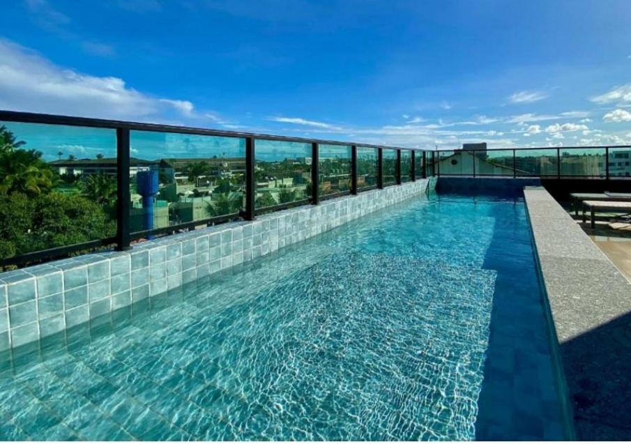 a swimming pool on the roof of a building at Flat 402 Centro Porto Galinhas in Porto De Galinhas