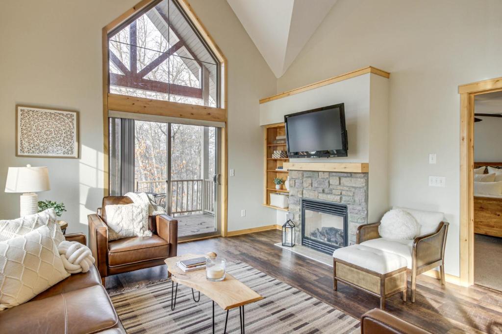 a living room with a fireplace and a tv at Nisswa Townhome with Boat Slip and Gull Lake Access! in Nisswa
