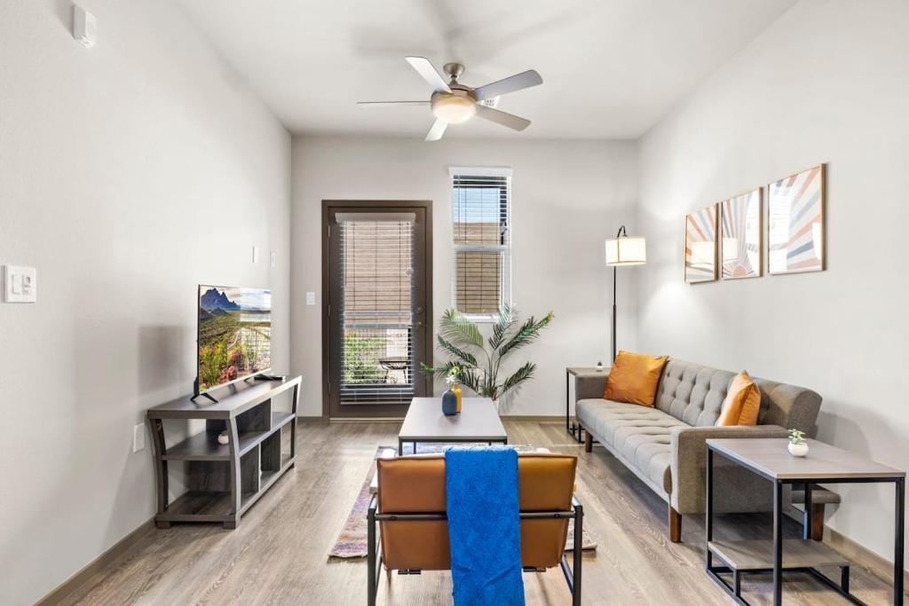 a living room with a couch and a table at Westgate CozySuites by stadium w pool 3 in Glendale