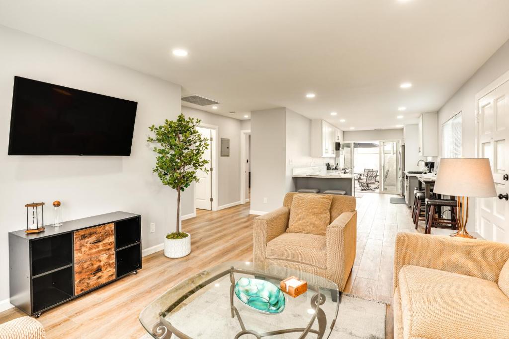 a living room with a fireplace and a tv on the wall at Rental with Pool Access about 8 Mi to Disneyland in La Palma