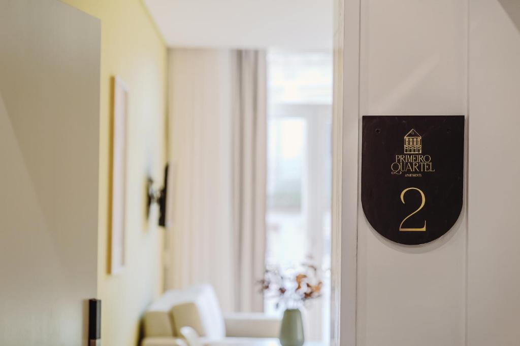 a sign on the door of a room with chairs at Primeiro Quartel Apartments - 2 in Peso da Régua