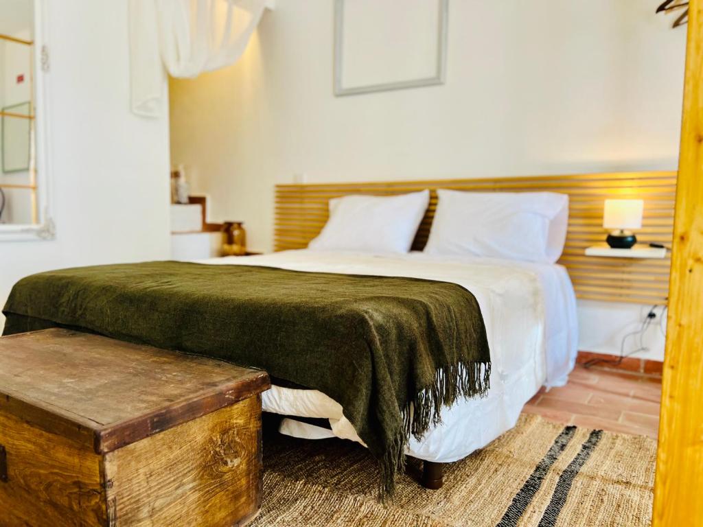 a bedroom with a large bed with a wooden headboard at Casa46 in Olhão