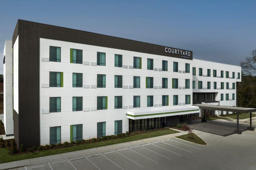 a white building with a sign on top of it at Courtyard by Marriott Northport in Northport