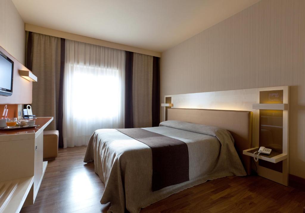 Postel nebo postele na pokoji v ubytování Hotel Velino