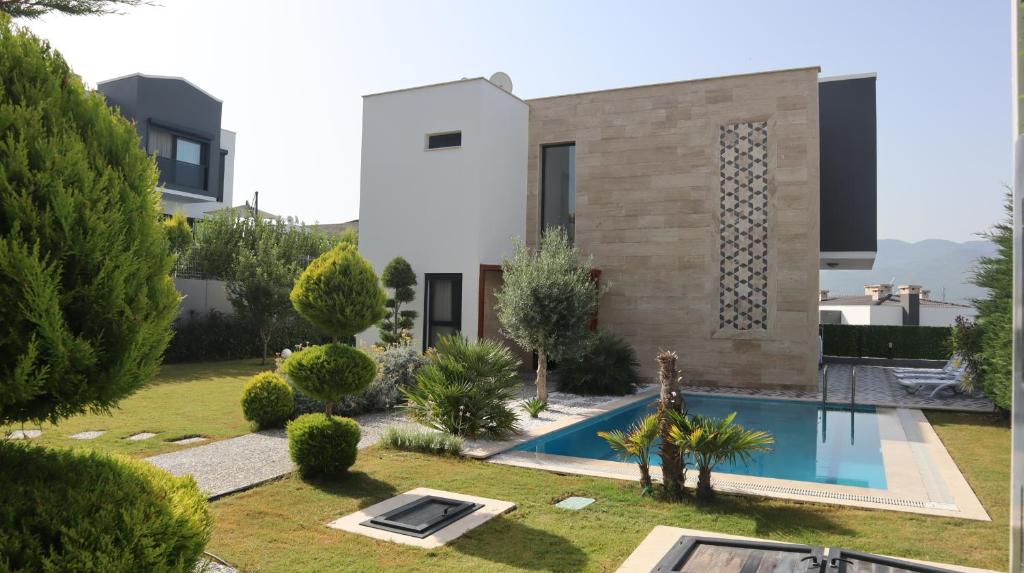 a villa with a swimming pool and a house at Villa Dream Kuşadası Pool- Garage in Kusadası