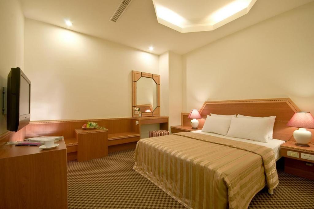 Postel nebo postele na pokoji v ubytování Good Ground Hotel Tainan