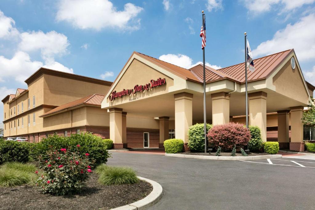 a front view of a hotel with an american flag at Hampton Inn & Suites Hershey in Hershey