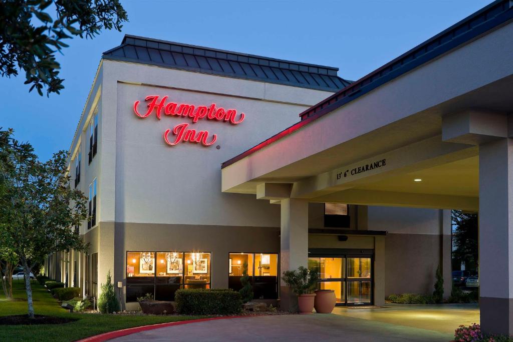 a hampton inn sign on the side of a building at Hampton Inn Houston Stafford in Stafford