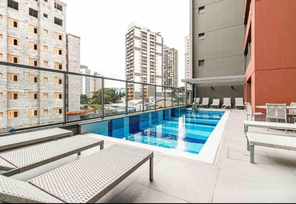 a balcony with a swimming pool on a building at 717 - Rentaqui Studio Elegance Butanta in Sao Paulo