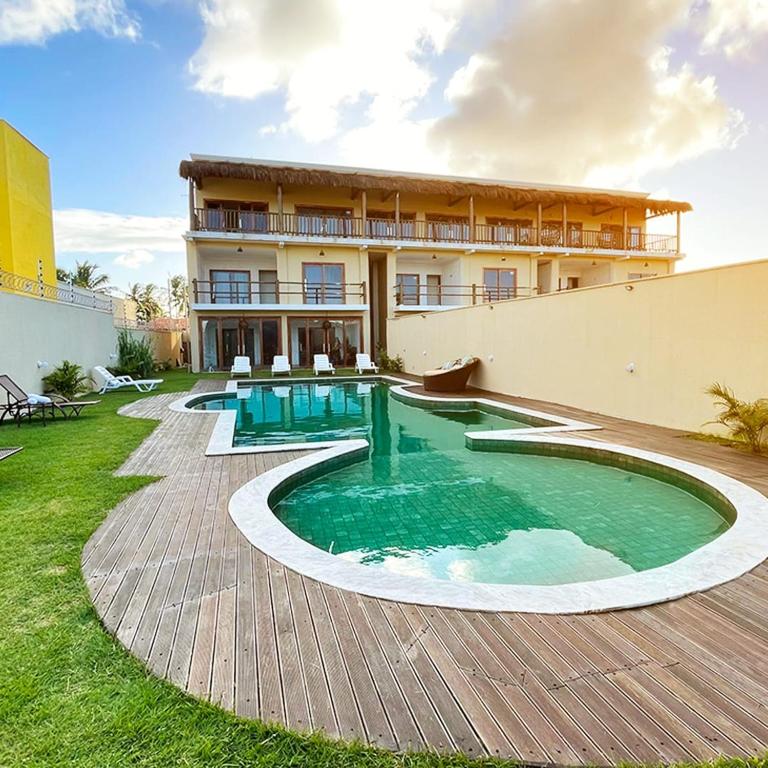 a house with a swimming pool in the yard at Pousada Gostoso Paradise in São Miguel do Gostoso
