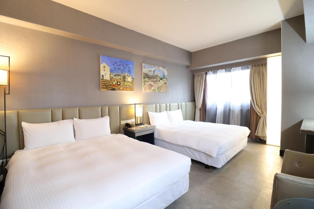 Postel nebo postele na pokoji v ubytování Kaohsiung Ahotel