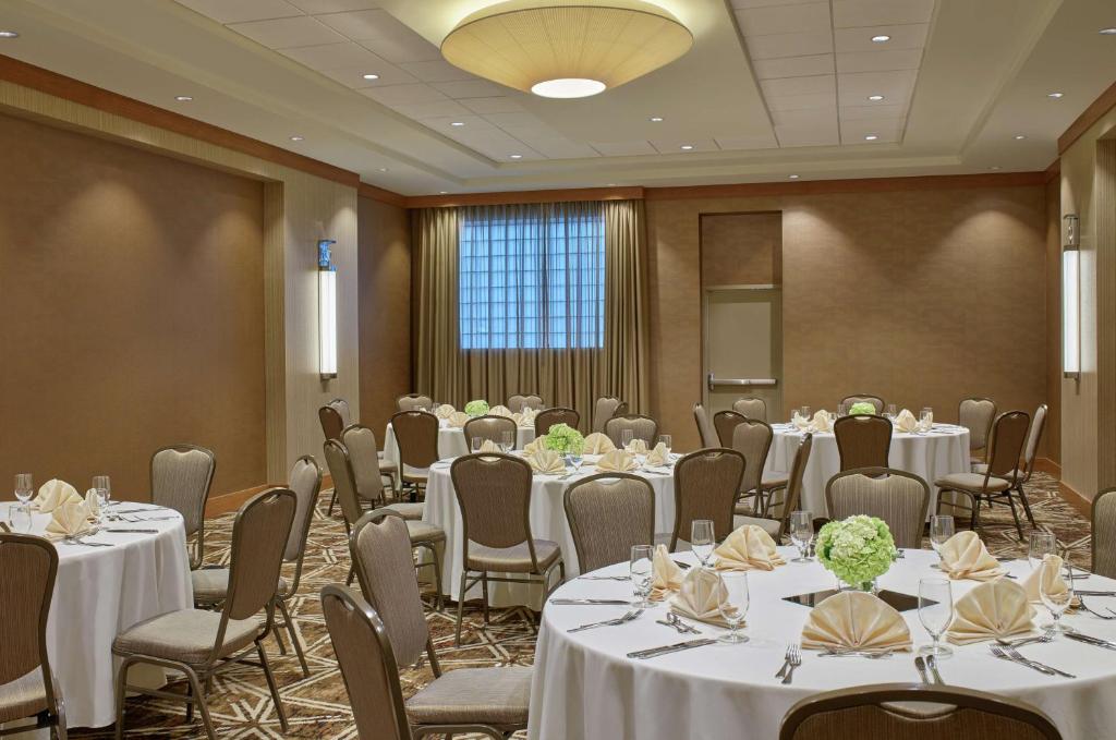 a conference room with tables and chairs with white tablecloths at DoubleTree by Hilton Houston Intercontinental Airport in Houston